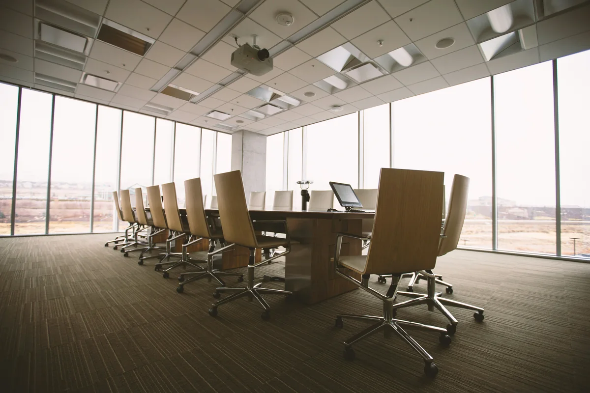 A quiet boardroom with chairs around a conference table